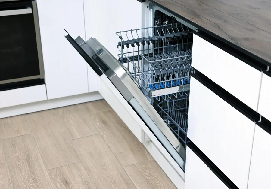Open dishwasher loaded with clean dishes in a modern kitchen